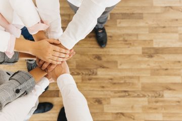 group-coworkers-putting-hands-together